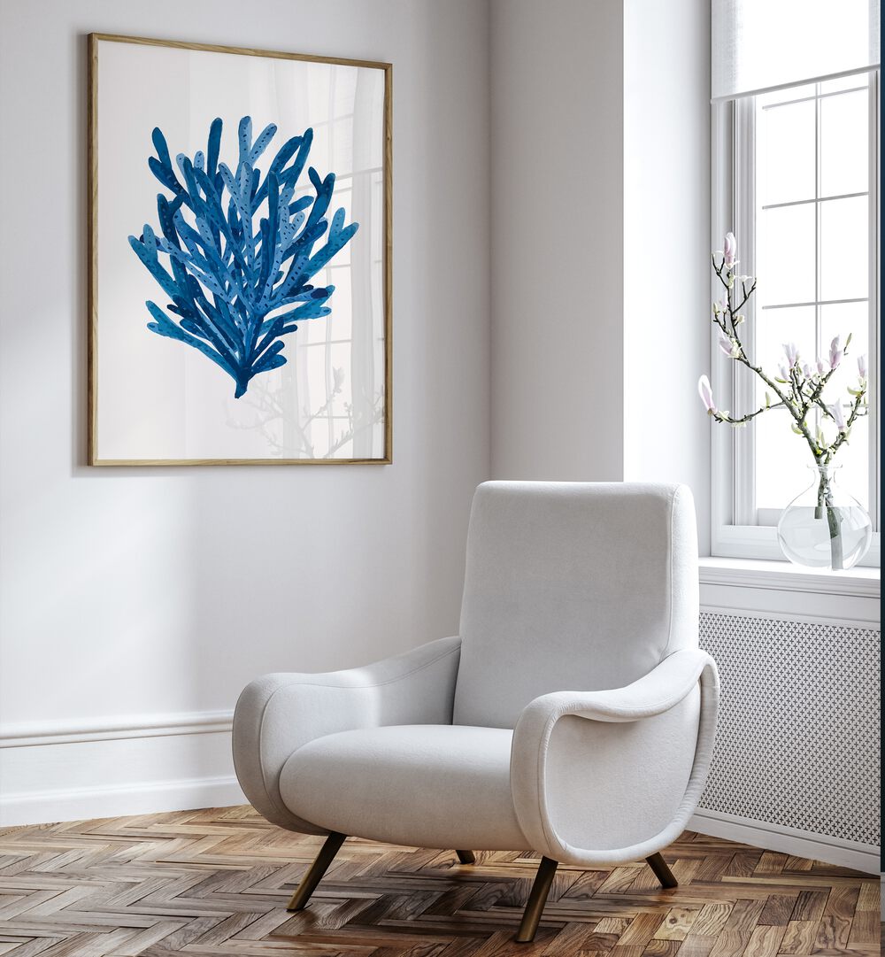 Vibrant CORAL, BEACH PAINTINGS adorn a wall, enhancing coastal vibes in a serene living space. Perfect for ocean lovers!