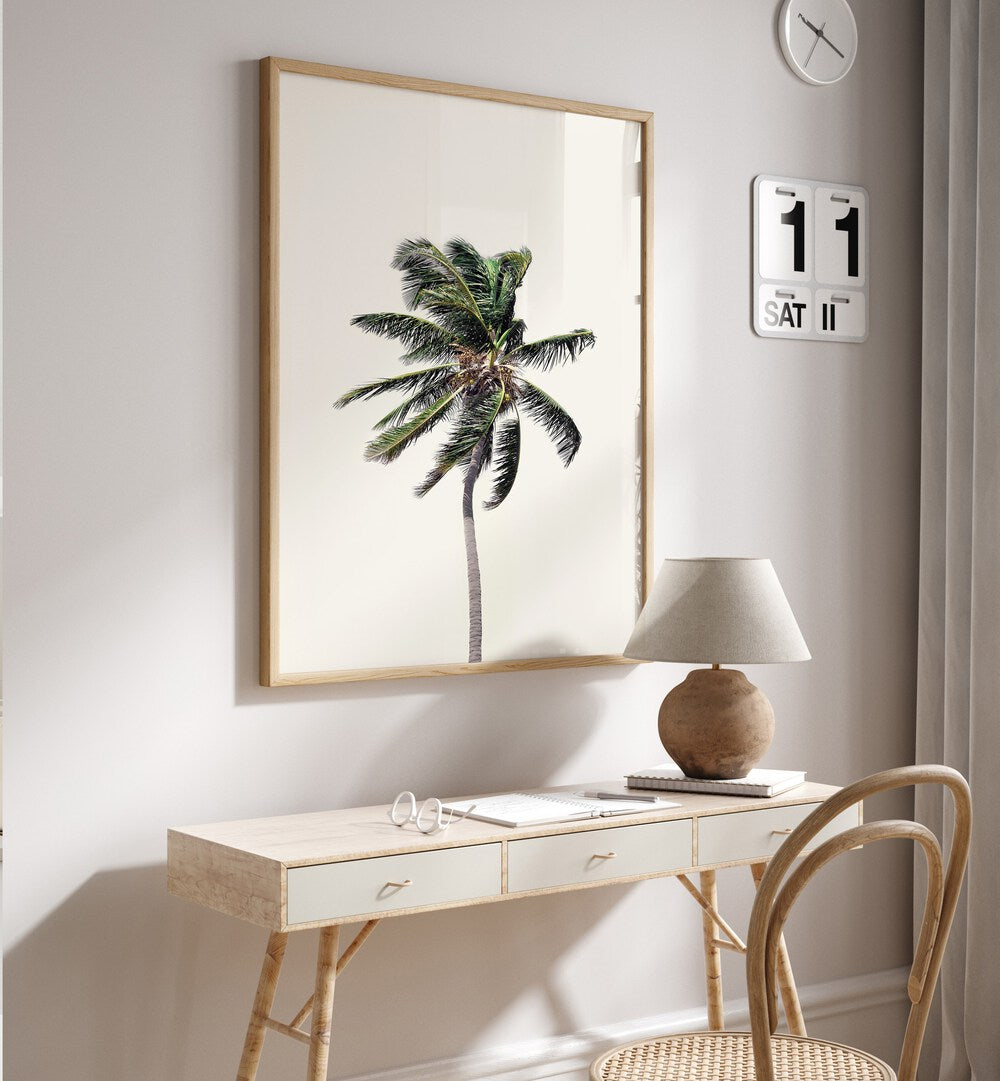 WINDY PALM TREE, FLORAL FLOWER PAINTINGS adorns a stylish desk, bringing a touch of tropical elegance to your space.