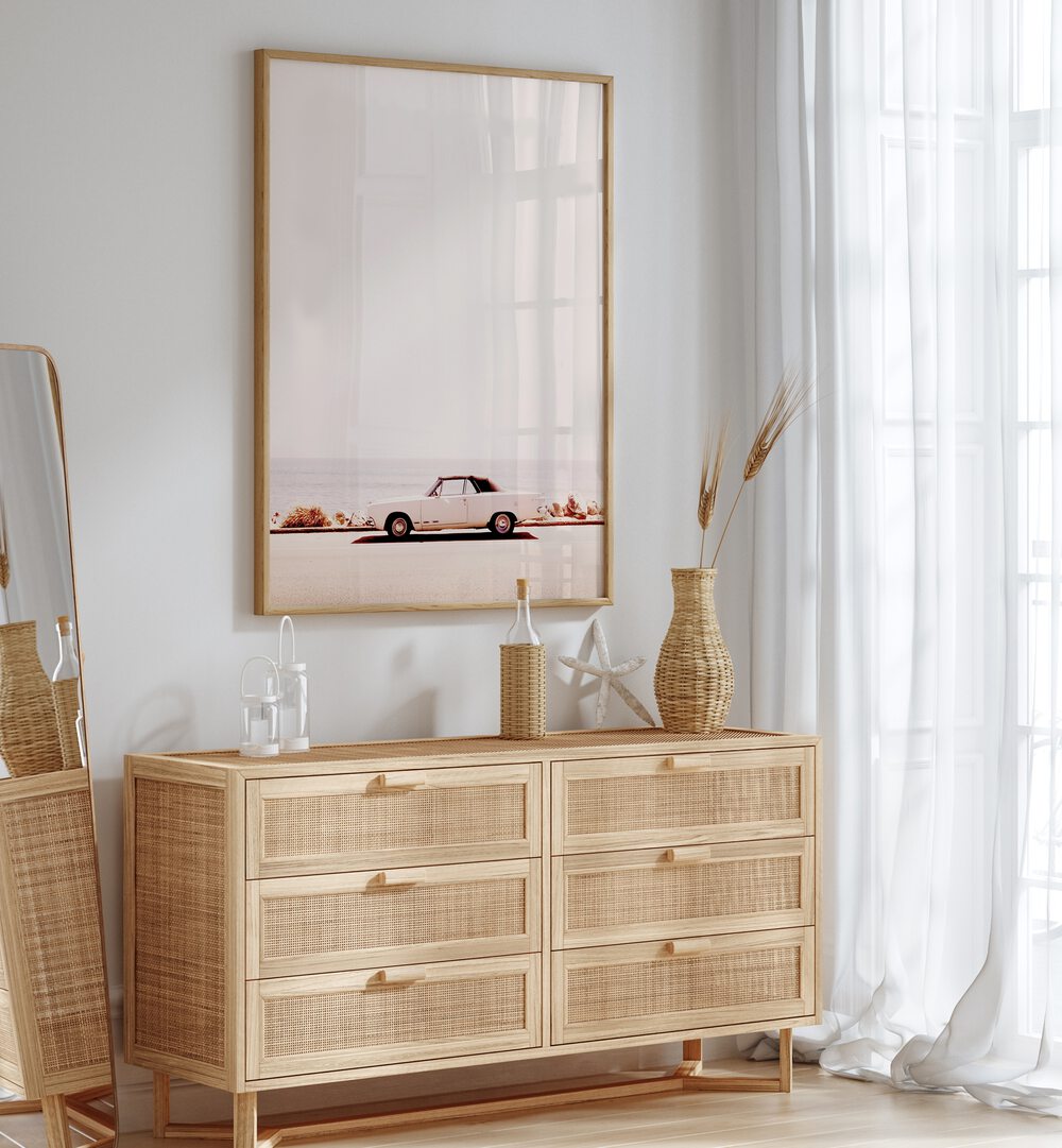 Stylish CALIFORNIA COAST, CAR POSTERS adorn a modern space with a vintage car, enhancing any decor with coastal vibes.