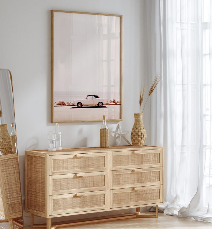 Stylish CALIFORNIA COAST, CAR POSTERS adorn a modern space with a vintage car, enhancing any decor with coastal vibes.