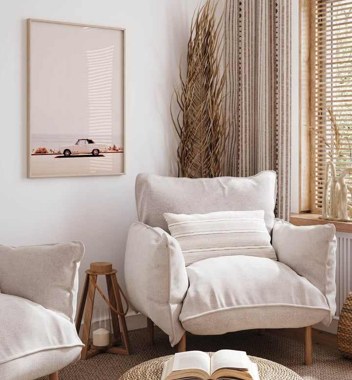 Stylish CALIFORNIA COAST, CAR POSTERS enhance this cozy living space with a vintage car and serene ocean backdrop.