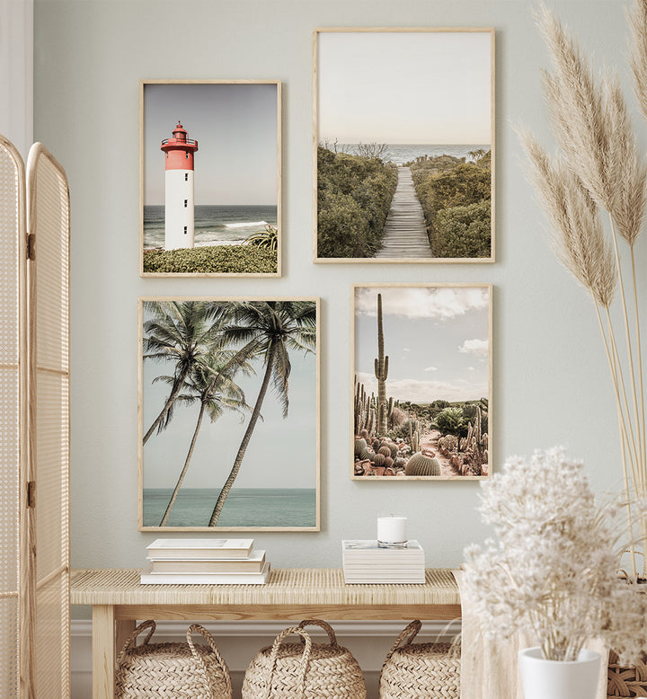 Wall with framed pictures of a lighthouse, beach, palm trees, and desert landscape.
