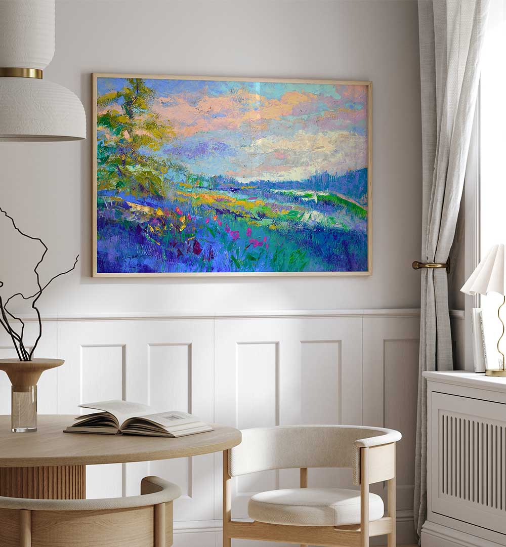 Framed IMPRESSIONIST , LANDSCAPE PAINTINGS with vivid blues, pinks and wildflower fields above a dining table in a modern neutral room