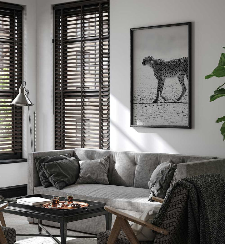 Framed black-and-white cheetah wall art above grey sofa in modern living room — SILENT PURSUIT , ANIMAL PAINTINGS
