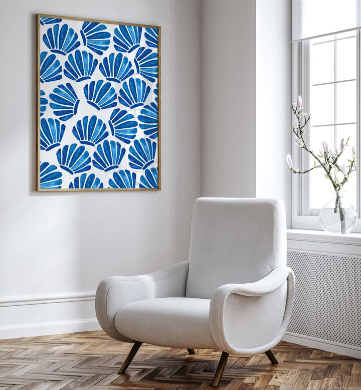 Stylish SHELL, BEACH PAINTINGS adorn a wall, enhancing a serene coastal ambiance in a modern living space.