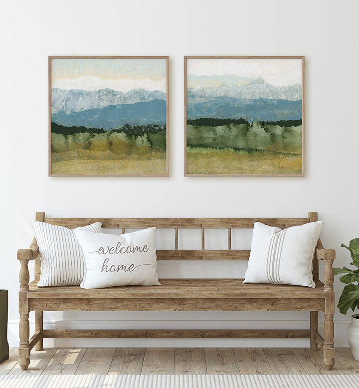 Wooden bench with 'welcome home' pillow, framed landscape art on wall