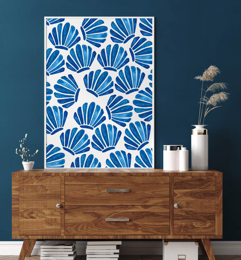 Bright blue SHELL, BEACH PAINTINGS adorn a stylish wooden console, bringing coastal charm to your home decor.