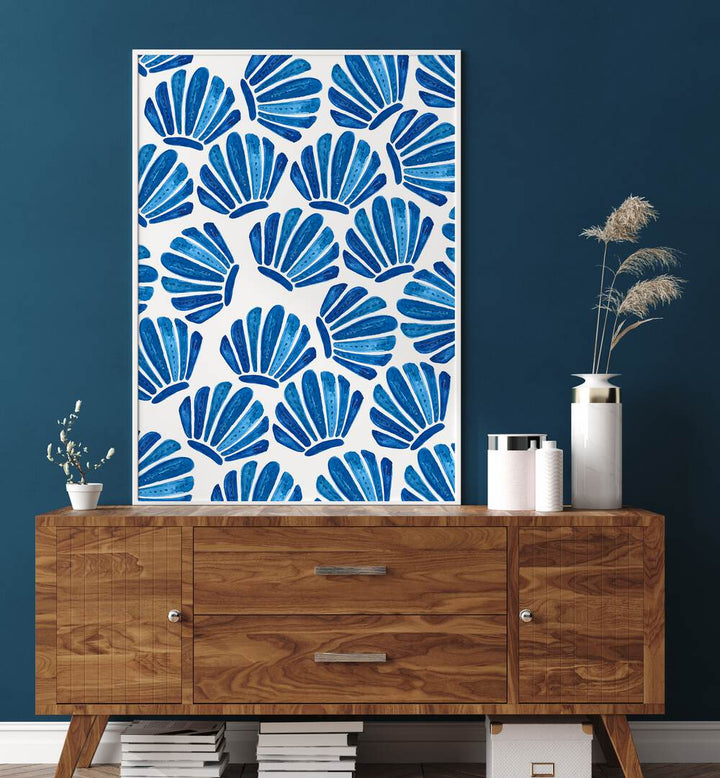 Bright blue SHELL, BEACH PAINTINGS adorn a stylish wooden console, bringing coastal charm to your home decor.