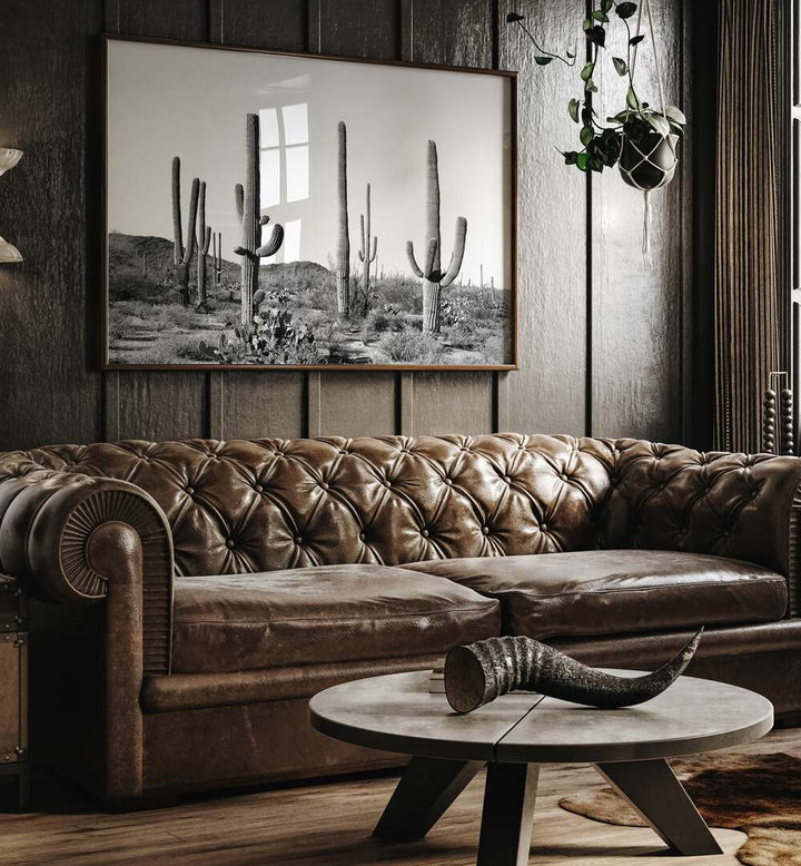 Stylish GREY CACTUS LAND, COWBOY painting enhances a modern living space with desert-inspired decor.