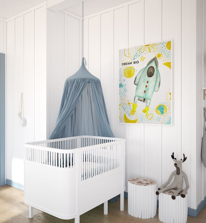 Bright and whimsical DREAM BIG, KIDS ROOM PAINTINGS enhance a cozy nursery with a playful rocket theme.