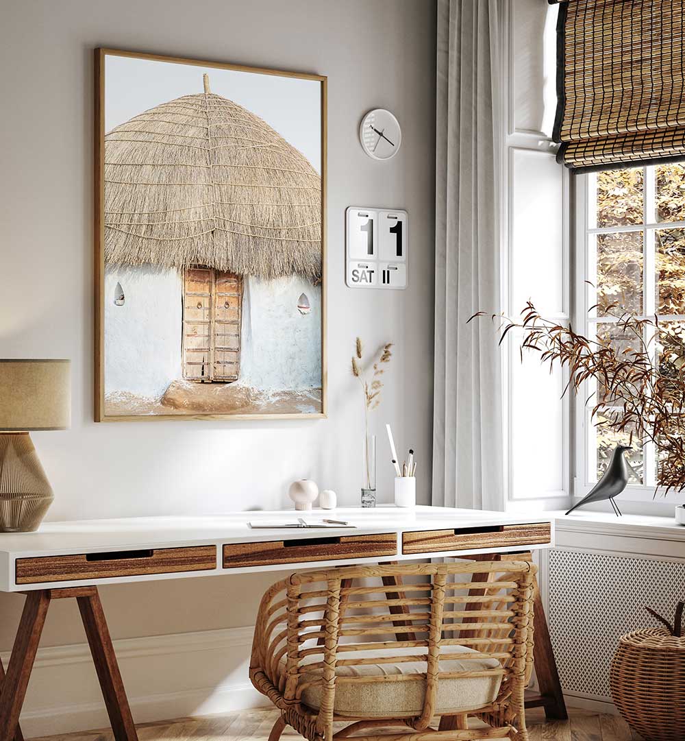 THATCHED HAVEN , INDIAN ART PAINTINGS framed rustic thatched hut art above desk in cozy neutral workspace