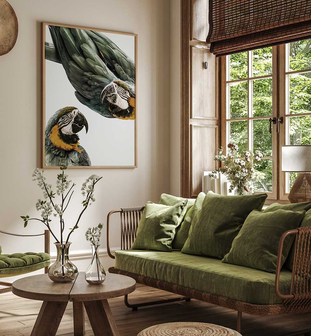 Framed VIBRANT PARROT DUO , ANIMAL PAINTINGS of two macaws above green sofa in sunlit living room