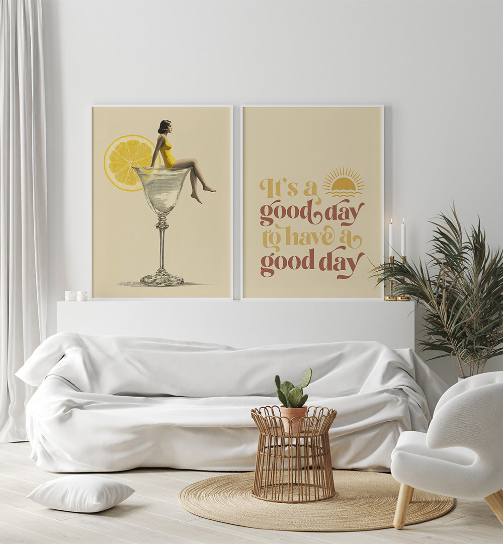 Modern living room with white sofa, decorative pillows, and wall art featuring a woman sitting on a lemon slice and a motivational quote.