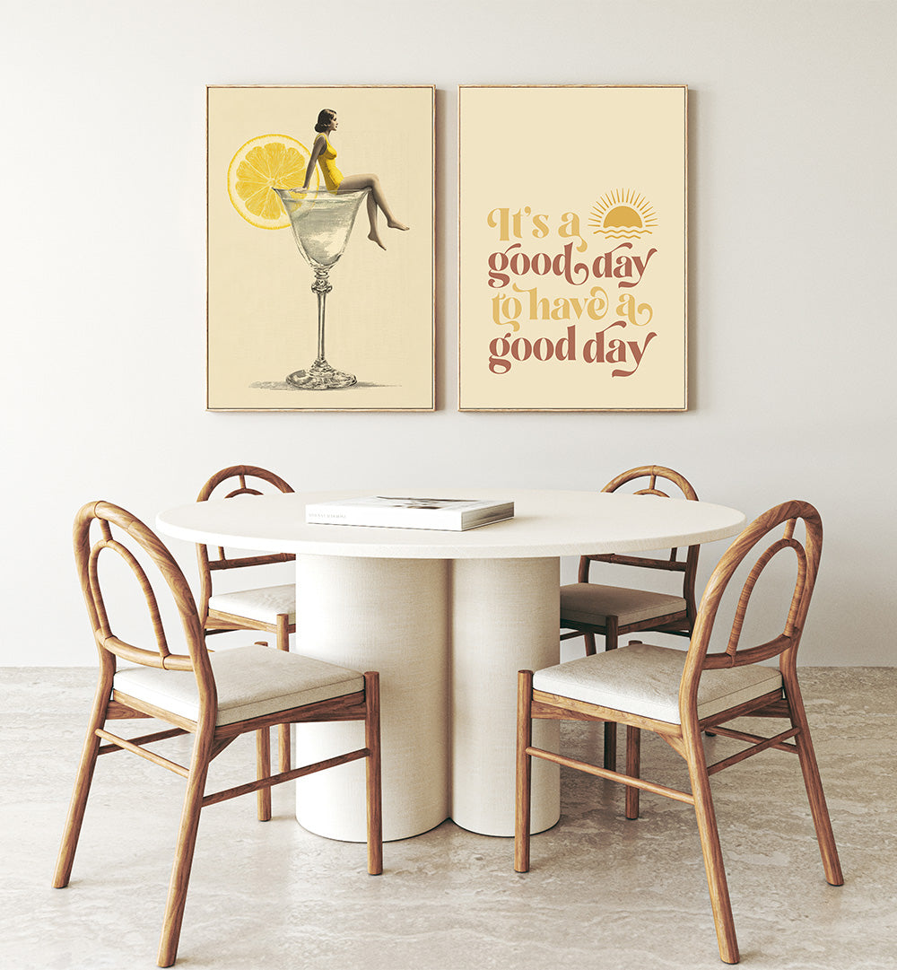 Dining area with a round table and chairs, featuring two framed artworks on the wall.