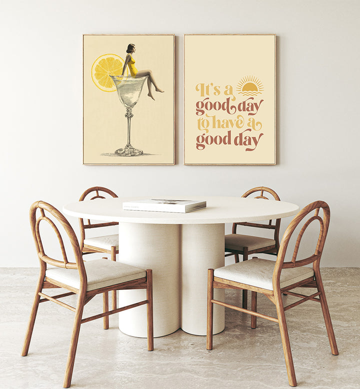 Dining area with a round table and chairs, featuring two framed artworks on the wall.