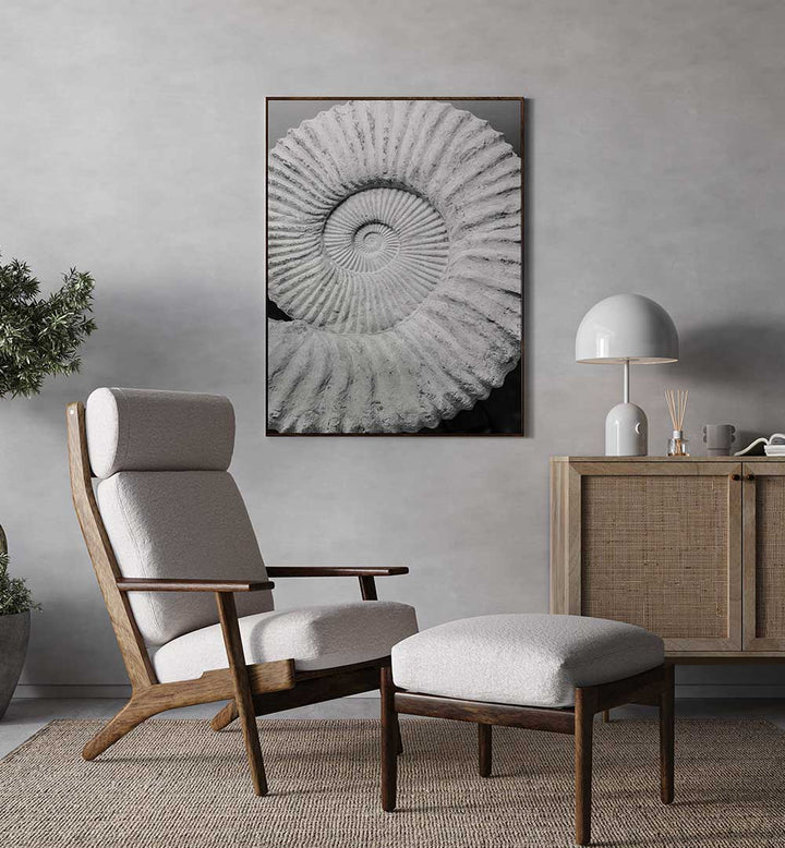 Framed ANCIENT SPIRAL DREAMS , BEACH PAINTINGS spiral fossil wall art above lounge chair in neutral living room