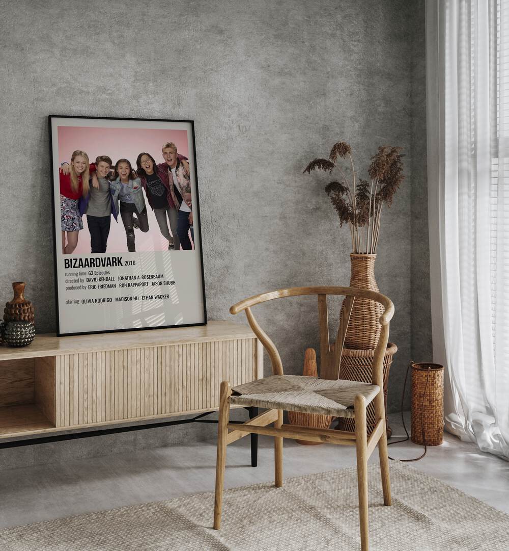 Bizaardvark 2016 Movie Posters in Black Plain Frame placed on a table beside oakwood chair