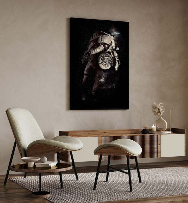 A Small World After All By Francis Minoza Astronaut & Nasa Paintings, Space Art Prints Artwork in Black Plain Frame placed on a Beige Colored Wall in the Drawing Room
