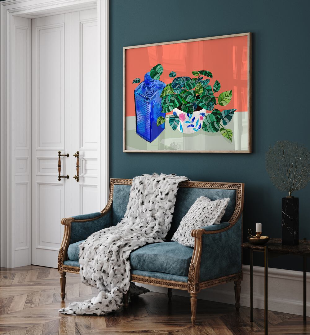 A Still Life Moment By Uma Gokhale Botanical Art Prints in Oak Wood Plain Frame on a green wall behind a sofa next to a door