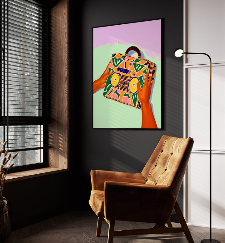 A Suitcase Full of Memories By Uma Gokhale Fashion Poster in Black Plain Frame beside an orange sofa on a wall