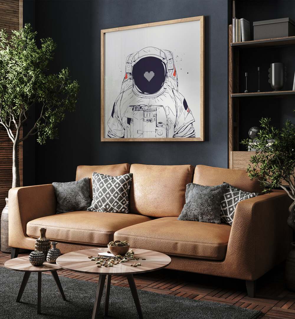 Astronaut Love By Balazs Solti Astronaut & Nasa Paintings, Space Art Prints Artwork in Oak Wood Plain Frame placed on a Blue Colored Wall near a Brown Sofa in the Living Room


