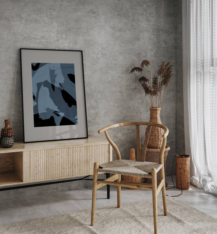 Abstract Brush Strokes Black And Blue By Mareike Bohmer Abstract Art Abstract Paintings in Black Plain Frame placed on a Console Table near a Grey Colored Wall in the Drawing Room