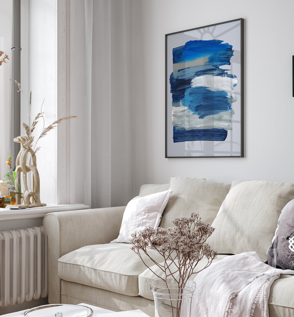 Abstract Brush Strokes Blue Mirage By Mareike Bohmer Abstract Art Abstract Paintings in Black Plain Frame placed on a White Colored Wall near a Cream Sofa in the Living Room