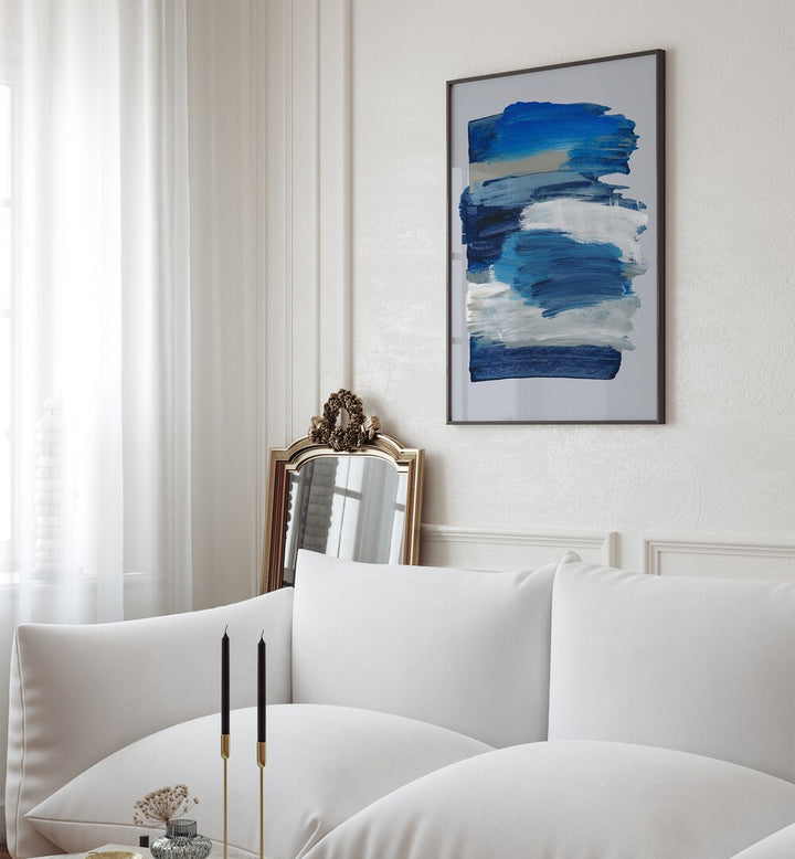 Abstract Brush Strokes Blue Mirage By Mareike Bohmer Abstract Art Abstract Paintings in Black Plain Frame placed on a White Colored Wall near a White Sofa in the Living Room