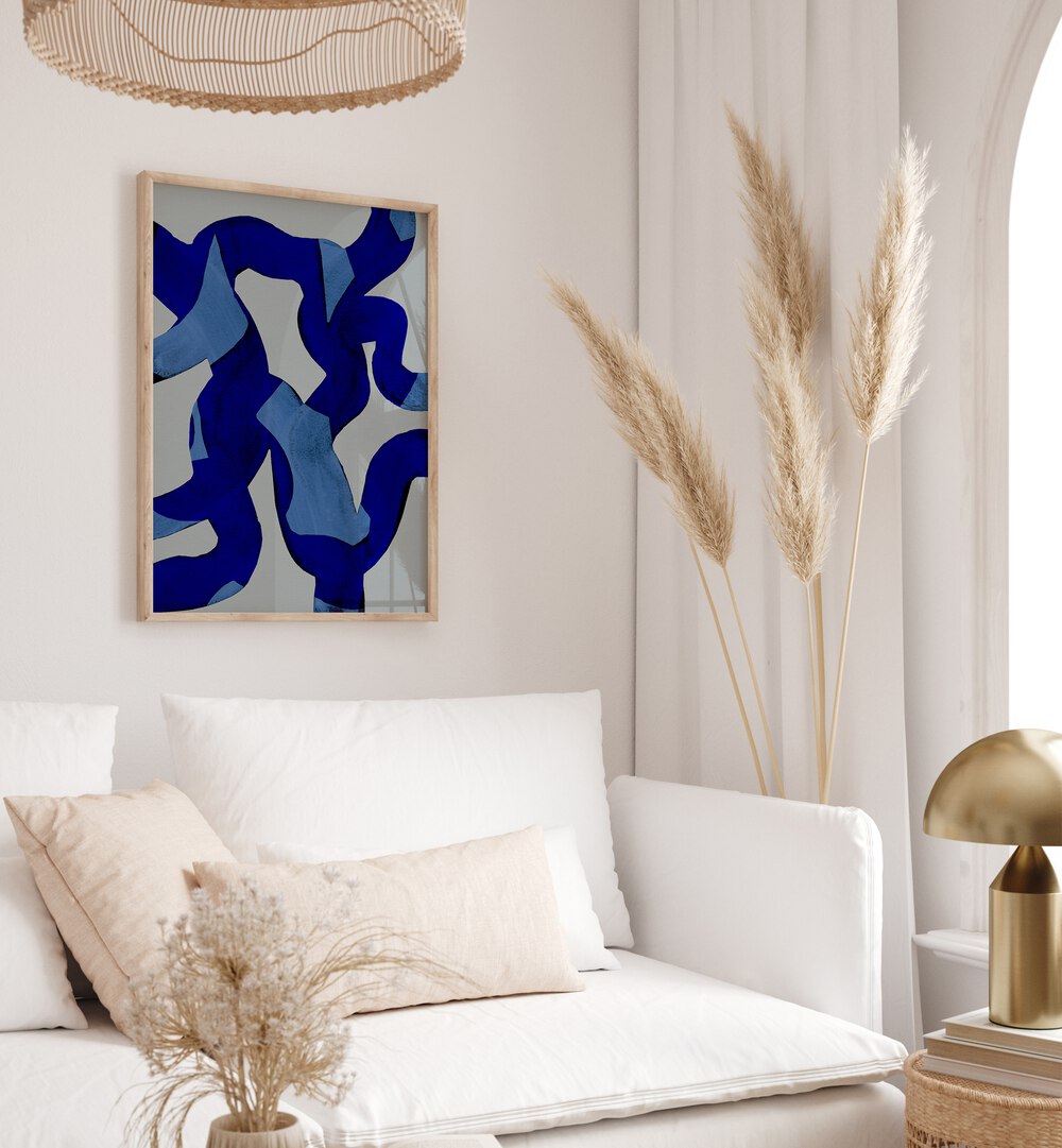 Abstract Brush Strokes Blue Tide By Mareike Bohmer Abstract Art Abstract Paintings in Oak Wood Plain Frame placed on a White Colored Wall near a White Sofa in the Living Room