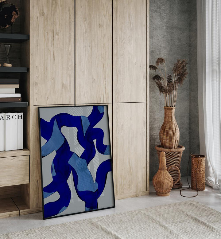 Abstract Brush Strokes Blue Tide By Mareike Bohmer Abstract Art Abstract Paintings in Black Plain Frame placed on the floor near a Wooden Cabinet in the Bedroom