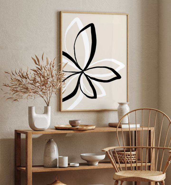 Abstract Flowers by Uplus Me Studio Floral Paintings Botanical Art Prints in Oak Wood Plain Frame placed on a wall behind a table 