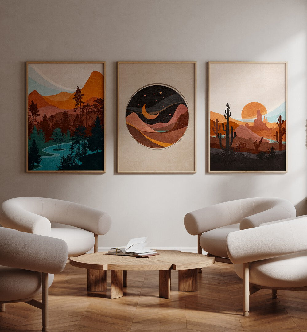 Abstract Landscape Set Of 3 Paintings in Oak Wood Plain Frame placed on a living room wall behind a sofa