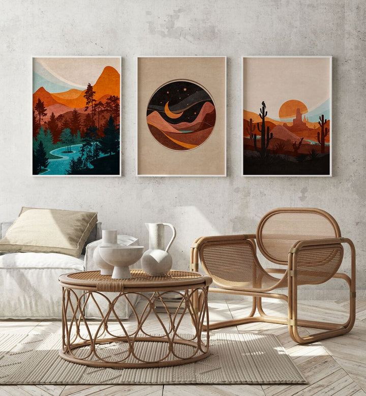 Abstract Landscape Set Of 3 Paintings in White Plain Frame placed on a wall behind a sofa and a chair