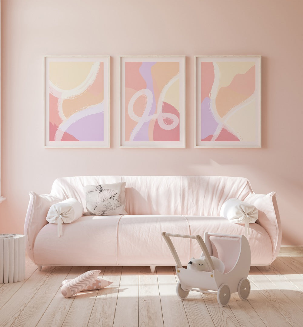 Abstract Ratios Set Of 3 Paintings in White Frame With Mount placed on a living room wall behind a sofa