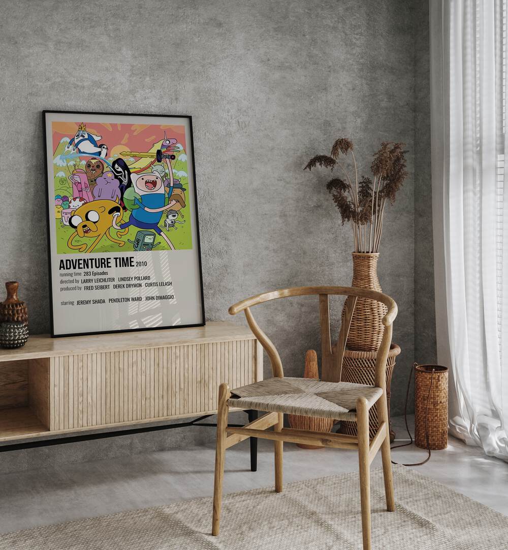 Adventure Time 2010 Movie Posters in Black Plain Frame placed on a table beside oakwood chair