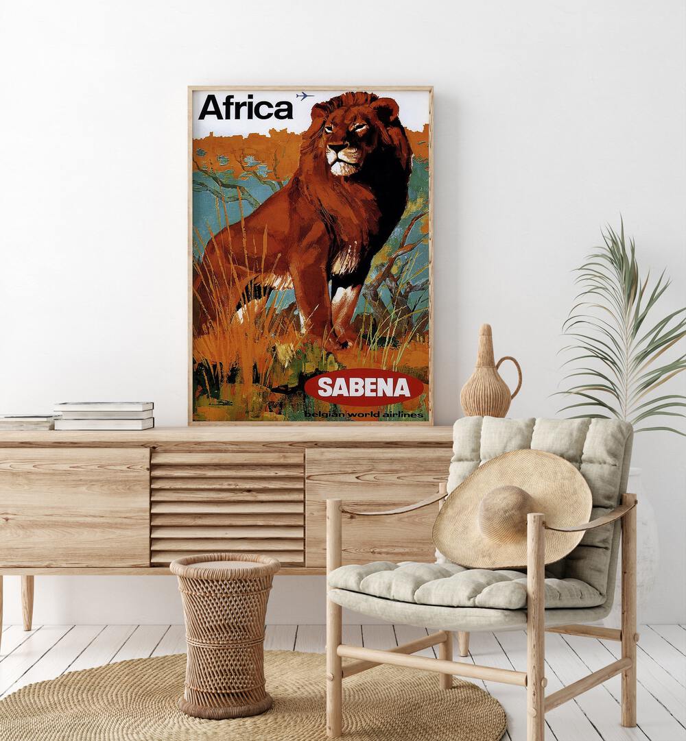 Africa-sabena Retro Vintage Travel Travel Posters in Oak Wood Plain Frame on a console table beside a plant