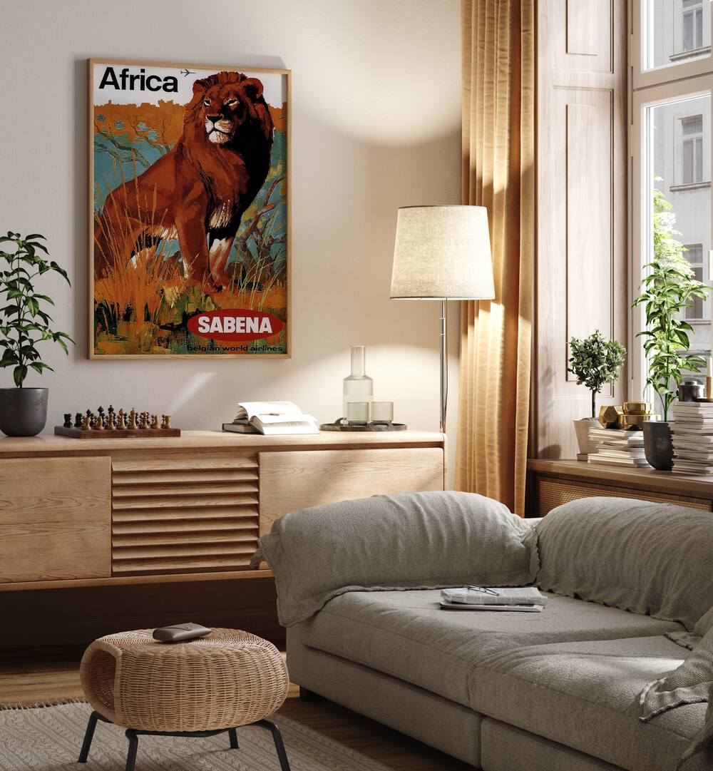 Africa-sabena Retro Vintage Travel Travel Posters in Oak Wood Plain Frame on a wall above a study table beside a lamp