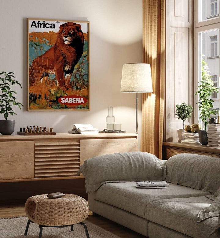 Africa-sabena Retro Vintage Travel Travel Posters in Oak Wood Plain Frame on a wall above a study table beside a lamp