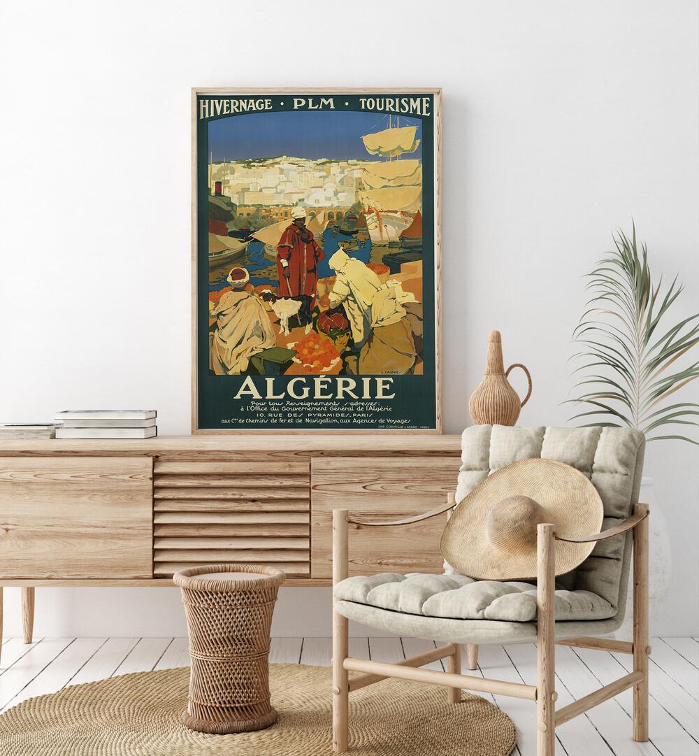 Algerie  Vintage Travel Posters in Oak Wood Plain Frame placed on a console table behind a chair