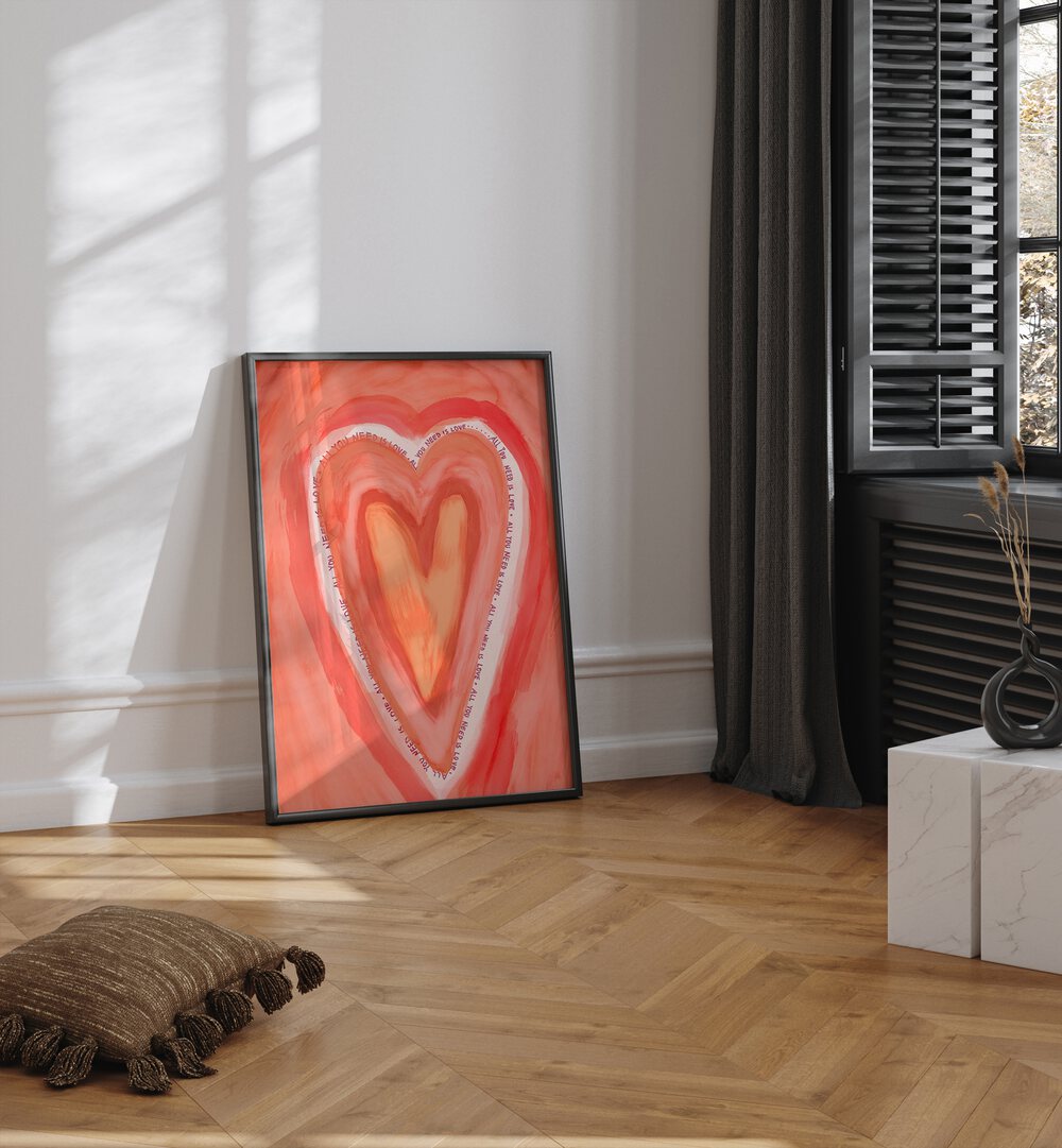 All You Need Is Love By Treechild Wall Art Prints in Black Plain Frame placed on the floor near a White Colored Wall in the Living Room