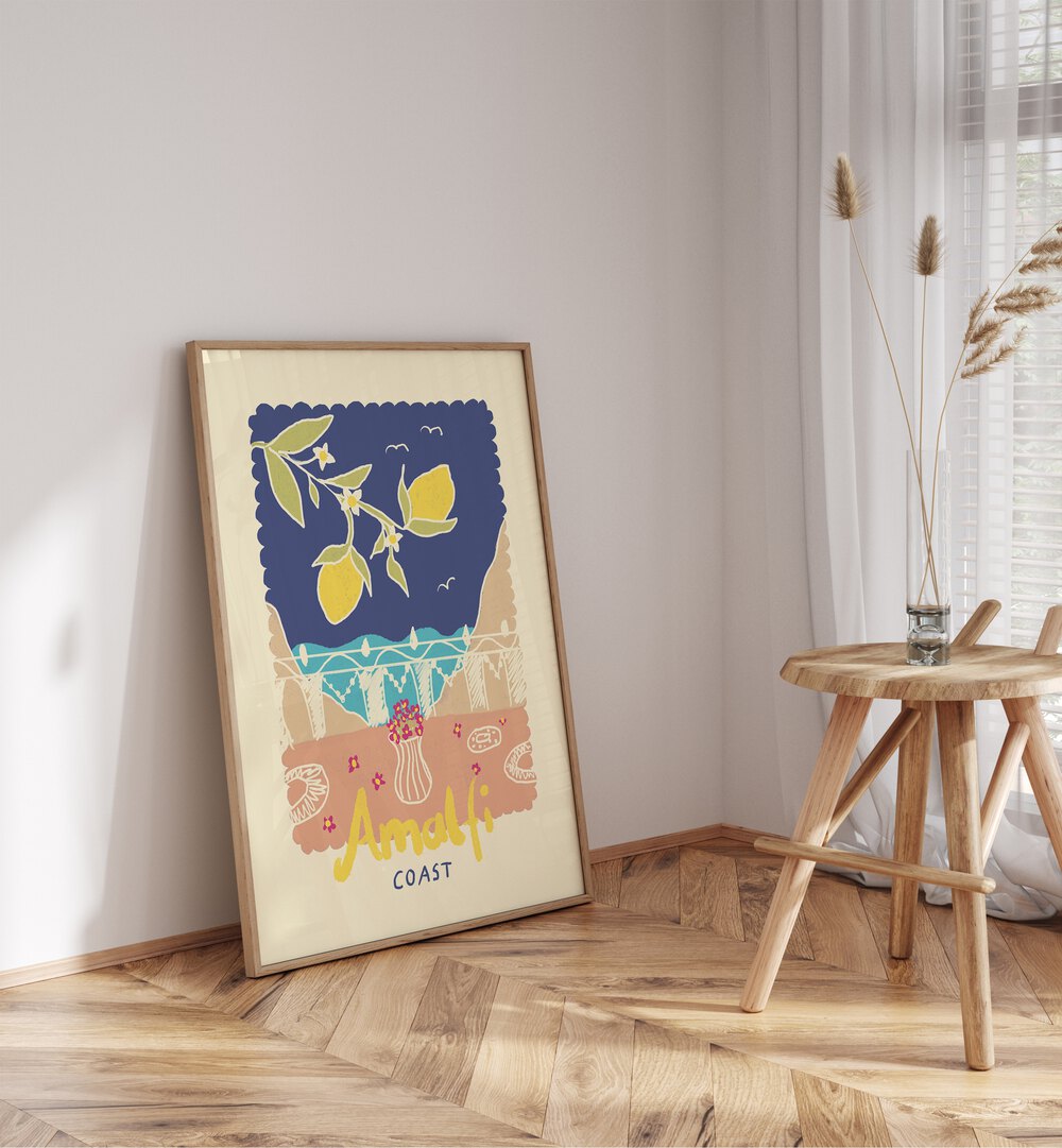 Amalfi Coast by Studio Dolci Kitchen Art Prints in Oak Wood Plain Frame placed on the floor beside a table