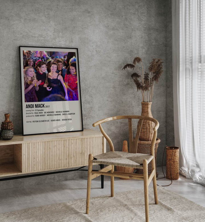 Andi Mack 2017 Movie Posters in Black Plain Frame placed on a table beside oakwood chair