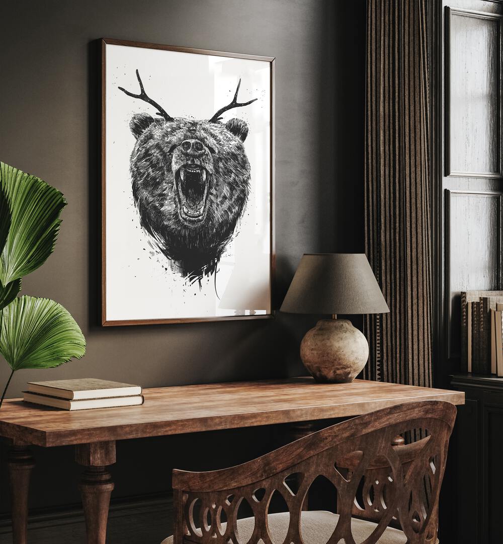 Angry Bear With Antlers By Balazs Solti Wildlife Art Prints in Dark Wood Plain Frame placed on a Brown Colored Wall near a Study Table in the Drawing Room