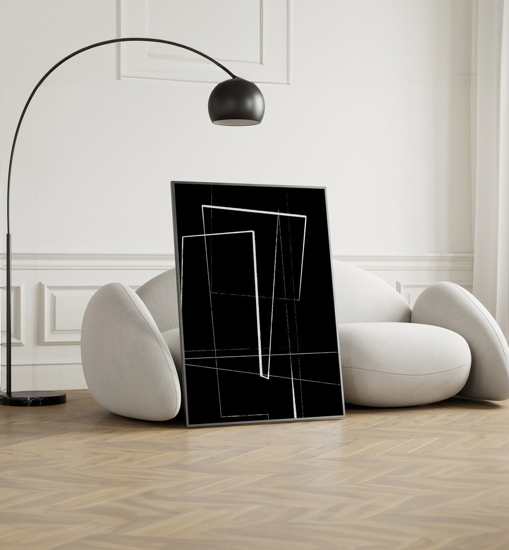 Angular Lines No III By Treechild Abstract Art Prints in Black Plain Frame placed on the floor near a White Sofa in the Living Room