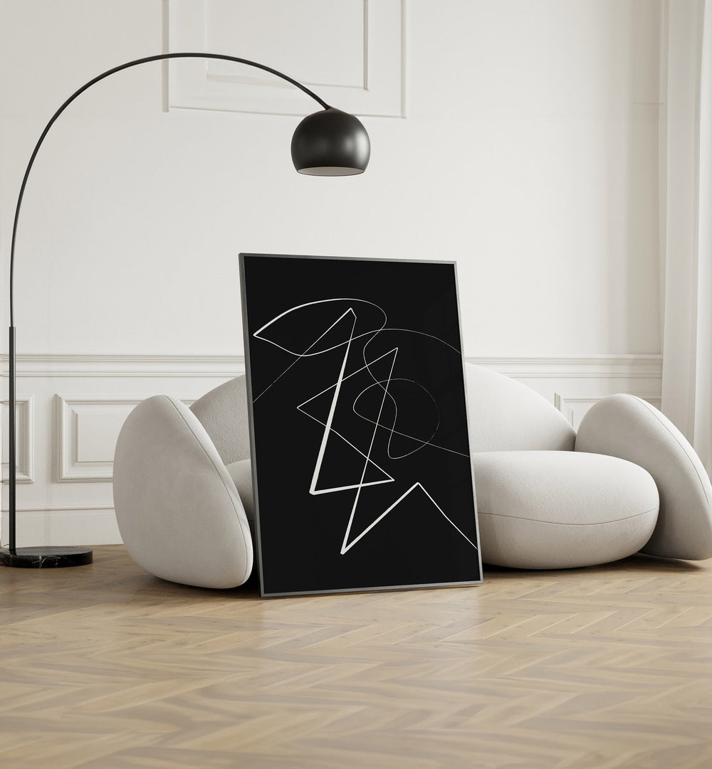 Angular Lines No VII By Treechild Abstract Art Prints in Black Plain Frame placed on the floor near a White Sofa in the Living Room