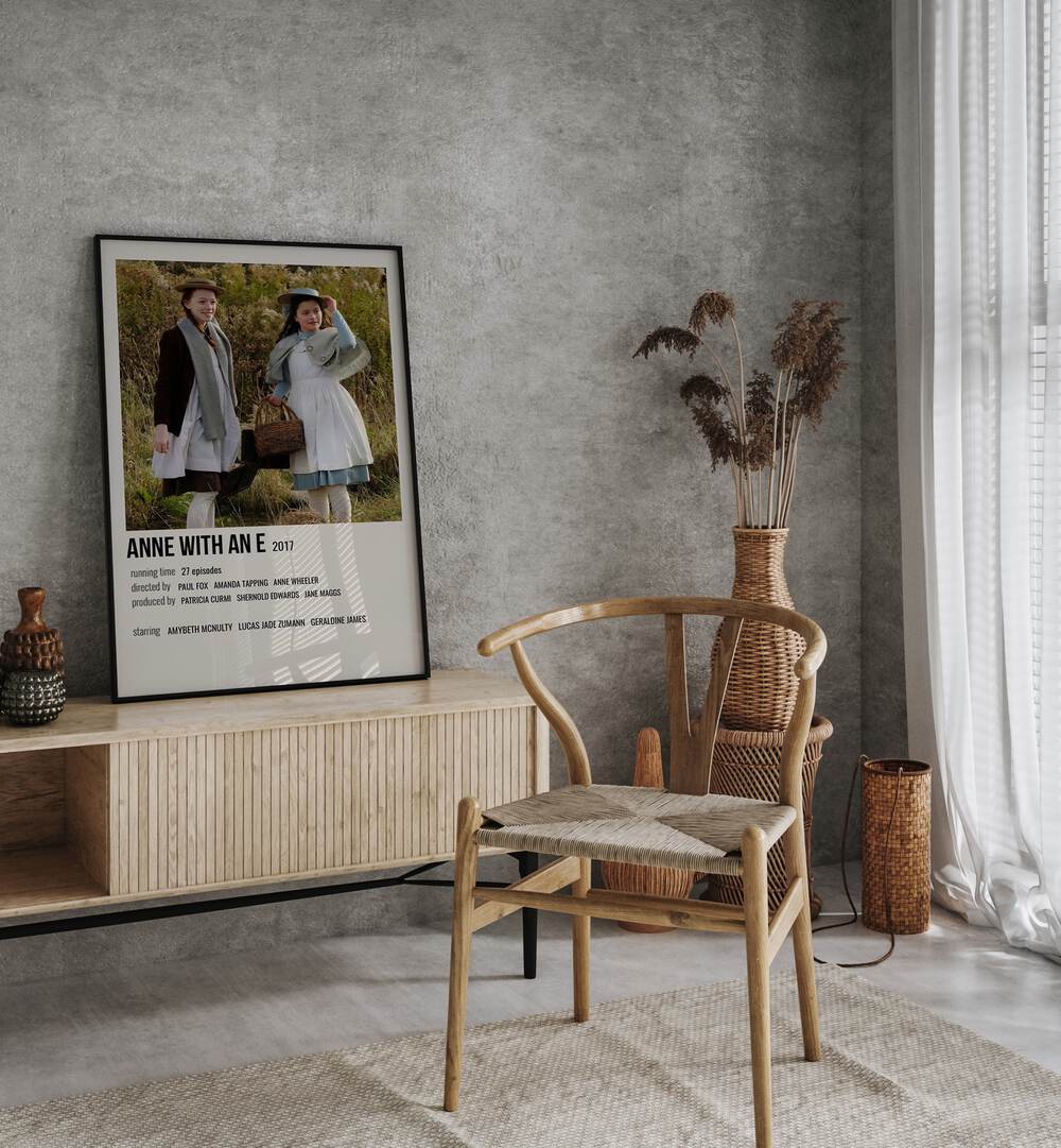 Anne With An E 2017 Movie Posters in Black Plain Frame placed on a table beside oakwood chair