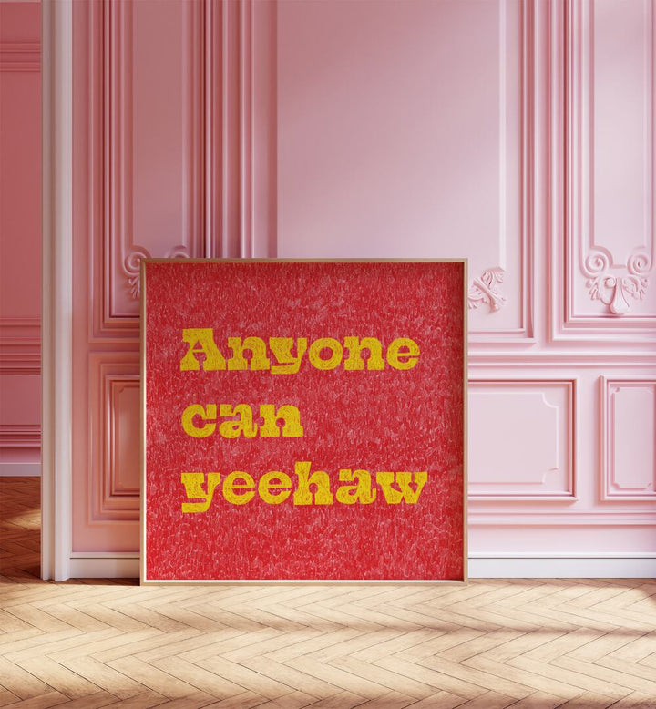 Anyone Can Yeehaw Quotes And Typography Posters in Oak Wood Plain Frame placed on the floor placed on a Pink Colored Wall in the Alley Way