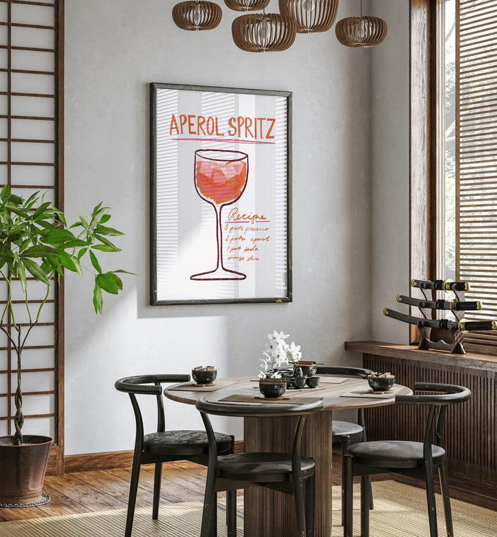 Aperol Spiritz by Athene Fritsch Cafe Art Prints Cafe Posters in Black Plain Frame placed on a wall in a dining room area beside a window and behind a dining table