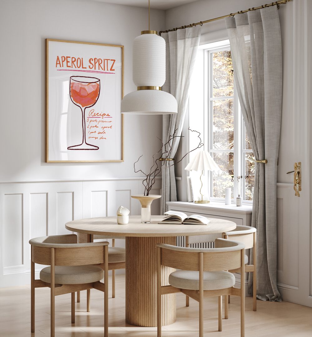 Aperol Spiritz by Athene Fritsch Cafe Art Prints Cafe Posters in Oak Wood Plain Frame placed on a wall in a dining room area beside a window and behind a dining table