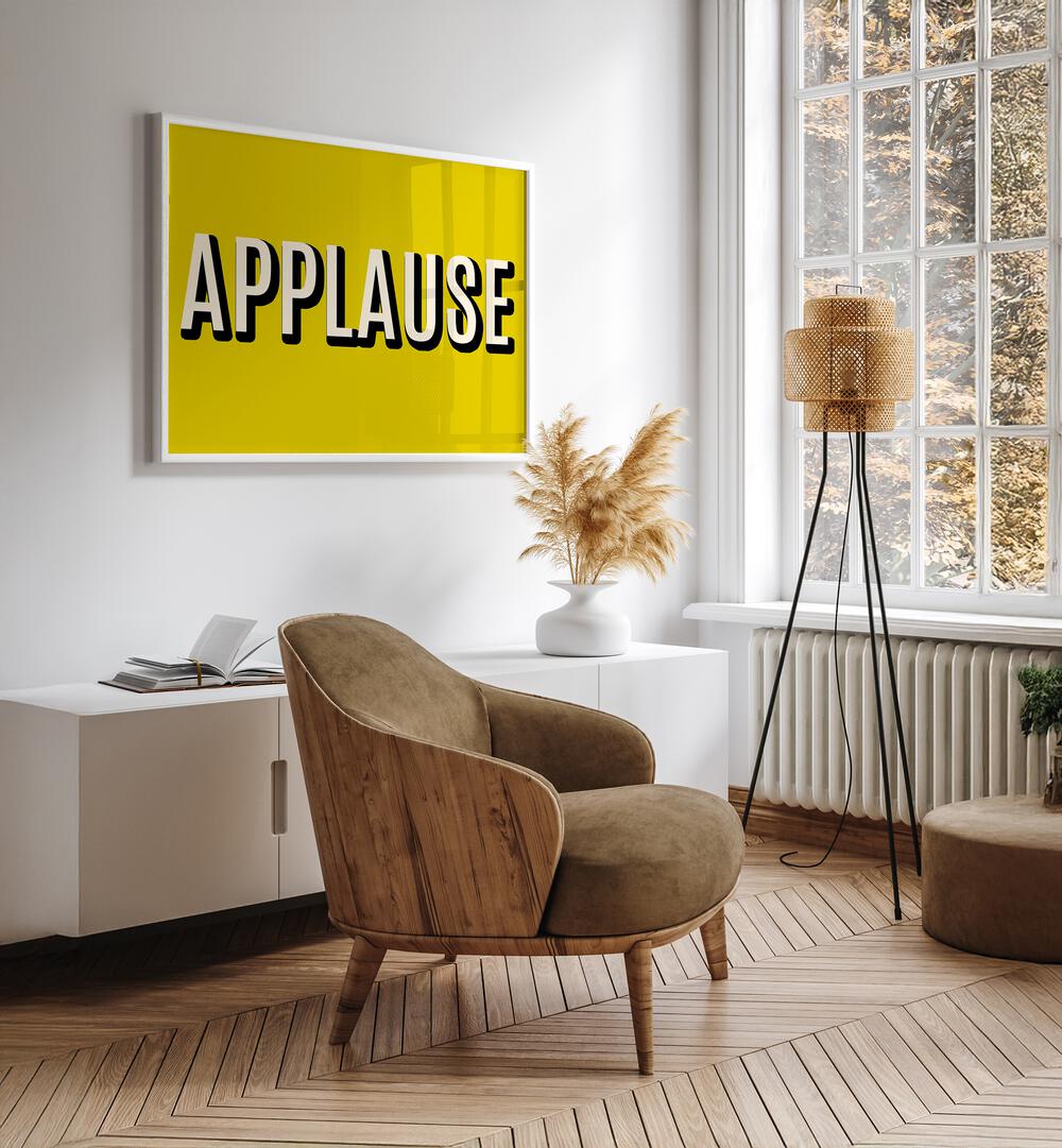 Applause Quotes And Typography Posters in White Plain Frame placed on a White Colored Wall above a Console Table in the Drawing Room